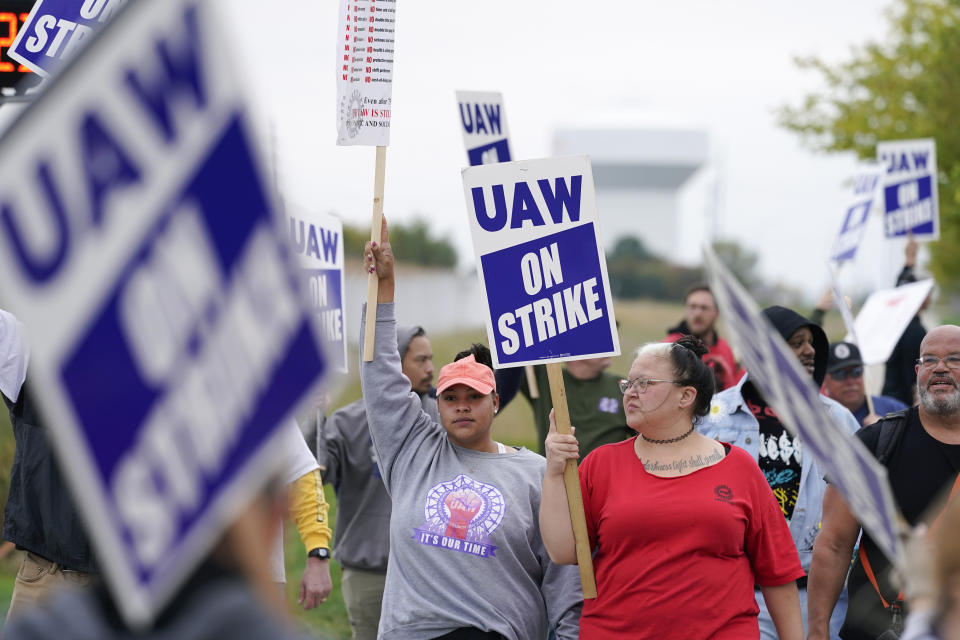 Members of the United Auto Workers strike outside of a John Deere plant, Wednesday, Oct. 20, 2021, in Ankeny, Iowa. About 10,000 UAW workers have gone on strike against John Deere since last Thursday at plants in Iowa, Illinois and Kansas. (AP Photo/Charlie Neibergall)