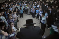 <p>Ultra-Orthodox Jewish men of the Vizhnitz Hassidic sect listen to their rabbi on a hill overlooking the Mediterranean Sea as they participate in a Tashlich ceremony in Herzeliya, Israel, Thursday, Sept. 28, 2017. Tashlich, which means “to cast away” in Hebrew, is the practice in which Jews go to a large flowing body of water and symbolically “throw away” their sins by throwing a piece of bread, or similar food, into the water before the Jewish holiday of Yom Kippur, which starts at sundown Friday. (Photo: Ariel Schalit/AP) </p>