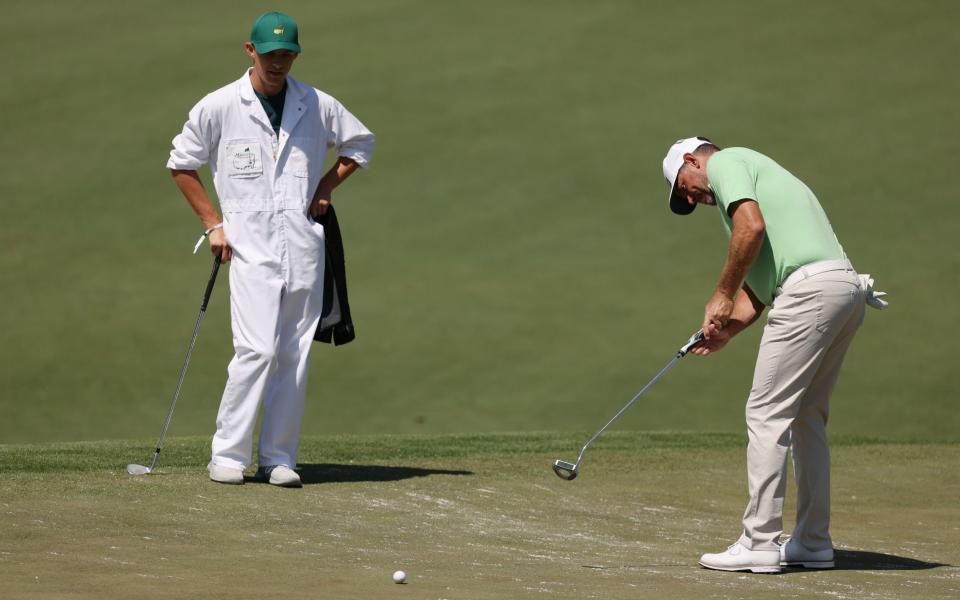 Lee Westwood of England putts as his caddie and son Sam Westwood - Getty Images