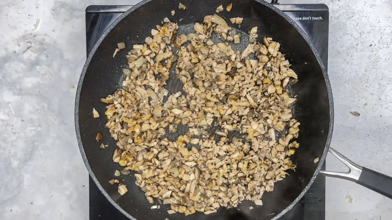 Mushroom and walnut mixture in frying pan