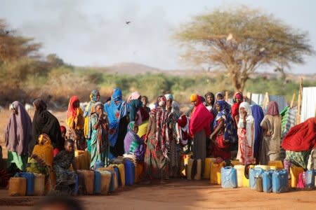 FILE PHOTO: Somali women wait to collect water at the New Kabasa internally displaced camp in the northern Somali town of Dollow, Somalia, February 25, 2018.  REUTERS/Baz Ratner