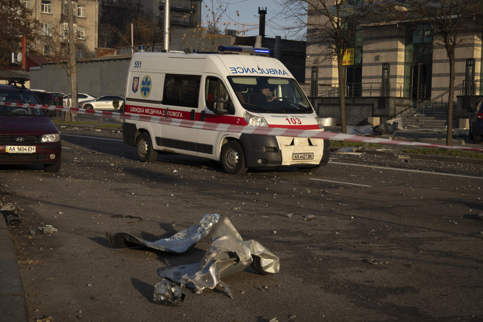 An ambulance drives past the debris of a building following a Russian missile attack in Kyiv, Ukraine, Friday, Dec. 29, 2023. Russia launched about 110 missiles as well as drones against Ukrainian targets during the night Ukraine President Volodymyr Zelenskyy said Friday, killing at least seven civilians in what appeared to be one of the biggest aerial barrages of the 22-month war. (AP Photo/Efrem Lukatsky)