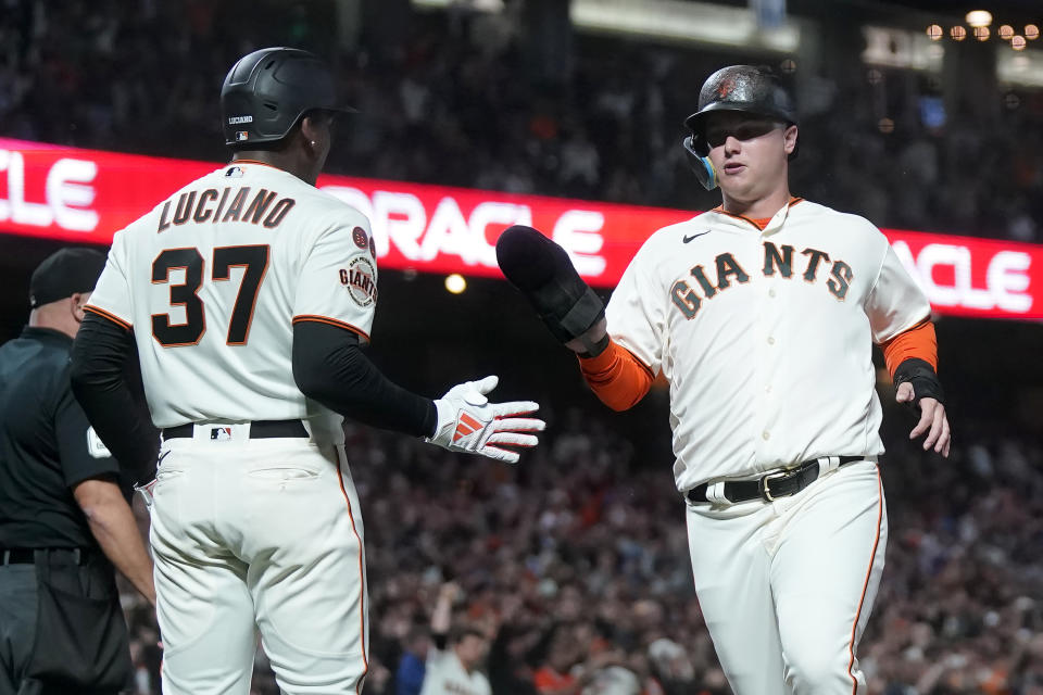 San Francisco Giants' Marco Luciano (37) celebrates with Joc Pederson after both scored on Michael Conforto's two-run single during the eighth inning of a baseball game against the San Diego Padres in San Francisco, Monday, Sept. 25, 2023. (AP Photo/Jeff Chiu)