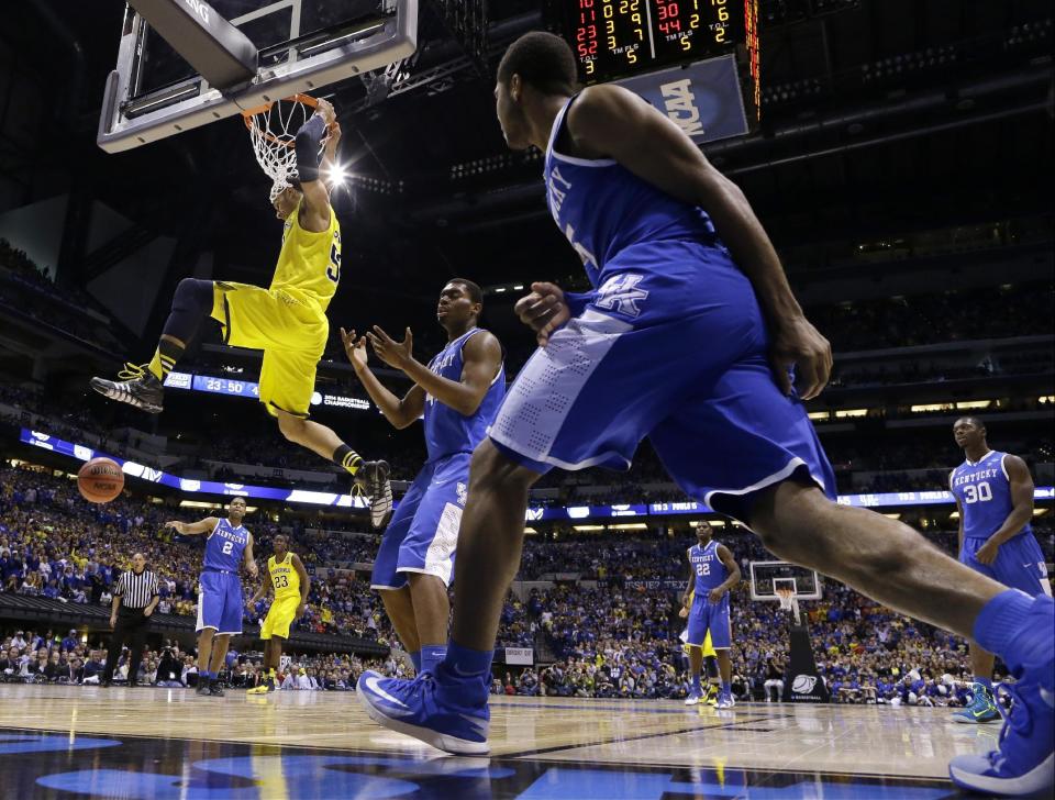 Michigan's Jordan Morgan dunks during the second half of an NCAA Midwest Regional final college basketball tournament game against Kentucky Sunday, March 30, 2014, in Indianapolis. (AP Photo/Michael Conroy)