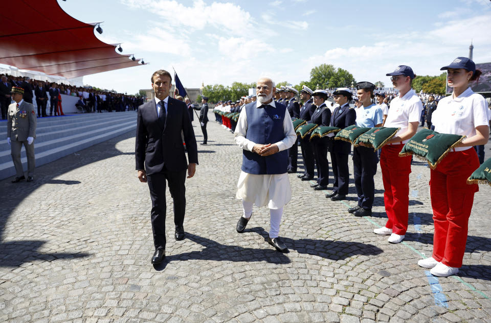 France's President Emmanuel Macron, left, and India's Prime Minister Narendra Modi attend the annual Bastille Day military parade, in Paris, Friday, July 14, 2023. India is the guest of honor at this year's Bastille Day parade, with Prime Minister Narendra Modi in the presidential tribune alongside French President Emmanuel Macron. (Gonzalo Fuentes/Pool via AP)