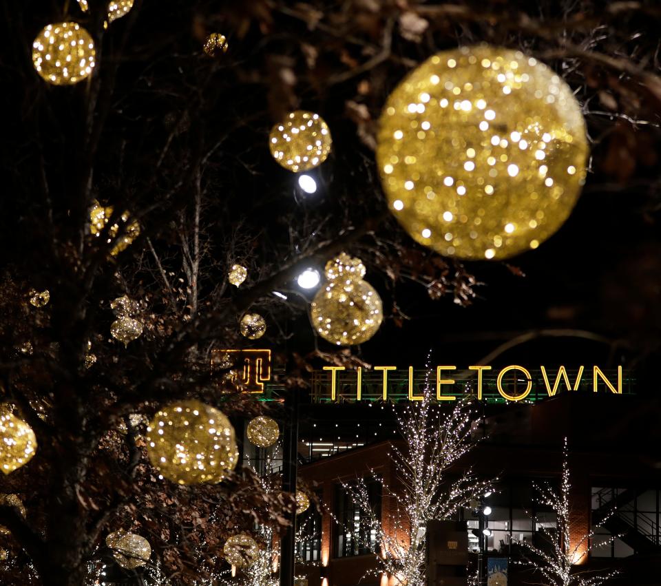 Holiday lights illuminate the Green Bay Packers' Titletown District in December.