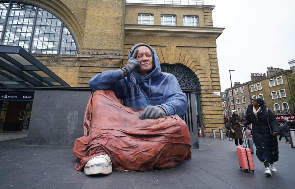 5 December 2022: Homeless charity Crisis unveil a 4.3 metre tall hyper-real sculpture of a person experiencing homelessness, at London King's Cross station in London (PA)