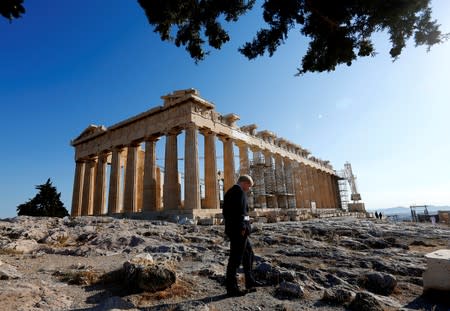 FILE PHOTO: Mayor of London Boris Johnson walks by the temple of Parthenon after an Olympic Flame ceremony atop the Athens Acropolis