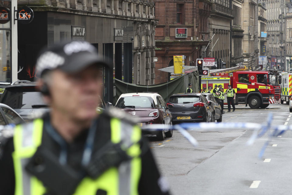 Emergency services attend the scene of an incident in Glasgow, Scotland, Friday June 26, 2020. Police in Glasgow say emergency services are currently dealing with an incident in the center of Scotland's largest city and are urging people to avoid the area. (Andrew Milligan/PA via AP)