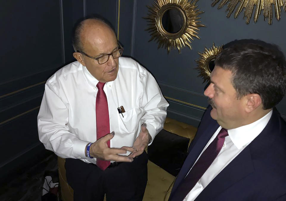 In this handout photo provided by Adriii Derkach's press office, Rudy Giuliani, an attorney for U.S President Donald Trump, left, meets with Ukrainian lawmaker Adriii Derkach in Kyiv, Ukraine, Thursday, Dec. 5, 2019. A Ukrainian lawmaker says he has met up with Rudy Giuliani, President Donald Trump’s personal attorney, in Kyiv to discuss an anti-corruption project. Derkach, who has previously accused the son of former Vice President Joe Biden of embezzling money from a gas company in Ukraine, posted photos of Thursday’s meeting on his Facebook page. (Adriii Derkach's press office via AP)