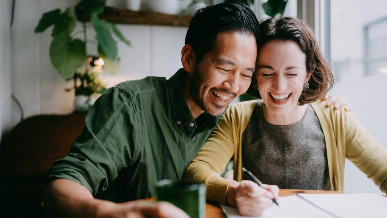 cheerful couple planning their future home