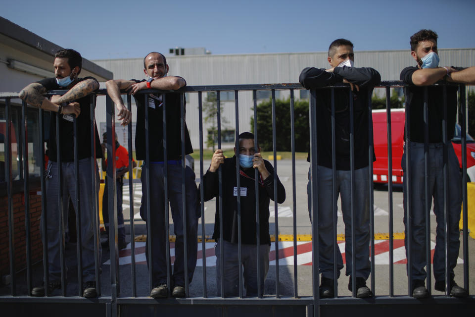 Nissan workers gather during a protest in Barcelona, Spain, Thursday, May 28, 2020. Japanese carmaker Nissan Motor Co. has decided to close its manufacturing plans in the northeastern Catalonia region, resulting in the loss of some 3,000 direct jobs. (AP Photo/Emilio Morenatti)