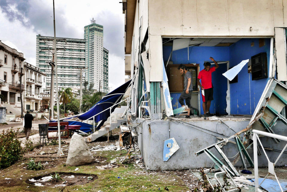 <p>Cubans clean their houses after the flooding, three days after Hurricane Irma passed over Cuba, on Sept. 12, 2017, in Havana, Cuba. Hundreds of thousands still have no power as Cuba is recovering from the impact by hurricane Irma. (Photo: Sven Creutzmann/Mambo photo/Getty Images) </p>