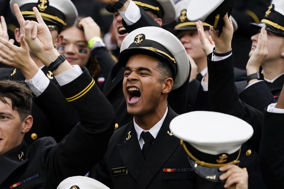 Navy midshipmen cheer during the first half of an NCAA college football game against Cincinnati, Saturday, Nov. 5, 2022, in Cincinnati. (AP Photo/Jeff Dean)