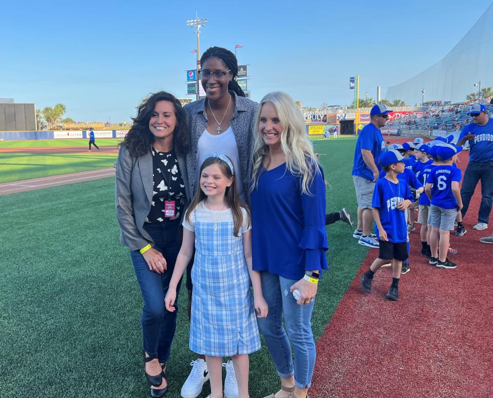 Former Pensacola star athletes Beth Barr, right, Michelle Snow, center, and Melissa Miller-Schubeck, stand with the National Anthem singer that night during the Blue Wahoos Women In Sports Night on April 21.