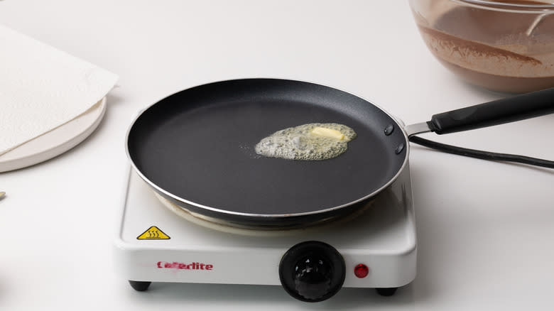 crepe pan with melted butter