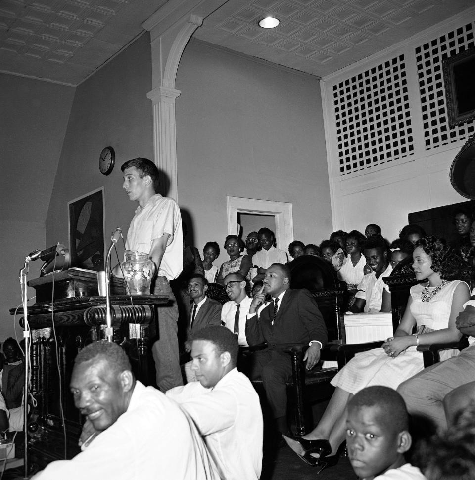 William Hansen, 23, of Cincinnati, Oh., speaking to a crowd in Albany, Ga., on July 14, 1962. Hansen, among those conducting Black voter registration efforts as part of the Albany Movement, said he planned to go to jail. Seated behind him, from left, are civil rights leaders C.T. Vivian, Wyatt T. Walker and Martin Luther King Jr. Coretta Scott King sits at far right. (AP Photo)