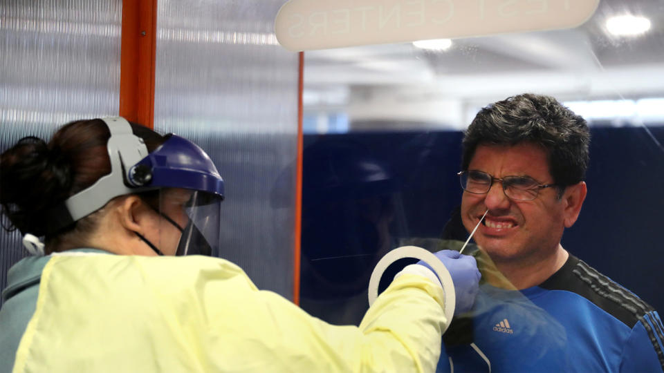 Luis Mostacero receives a Covid-19 test from testing technician Jamie Kunzer at Doctors Test Centers at Chicago's O'Hare International Airport on Thursday, May 20, 2021. (Chris Sweda/Chicago Tribune/Tribune News Service via Getty Images)