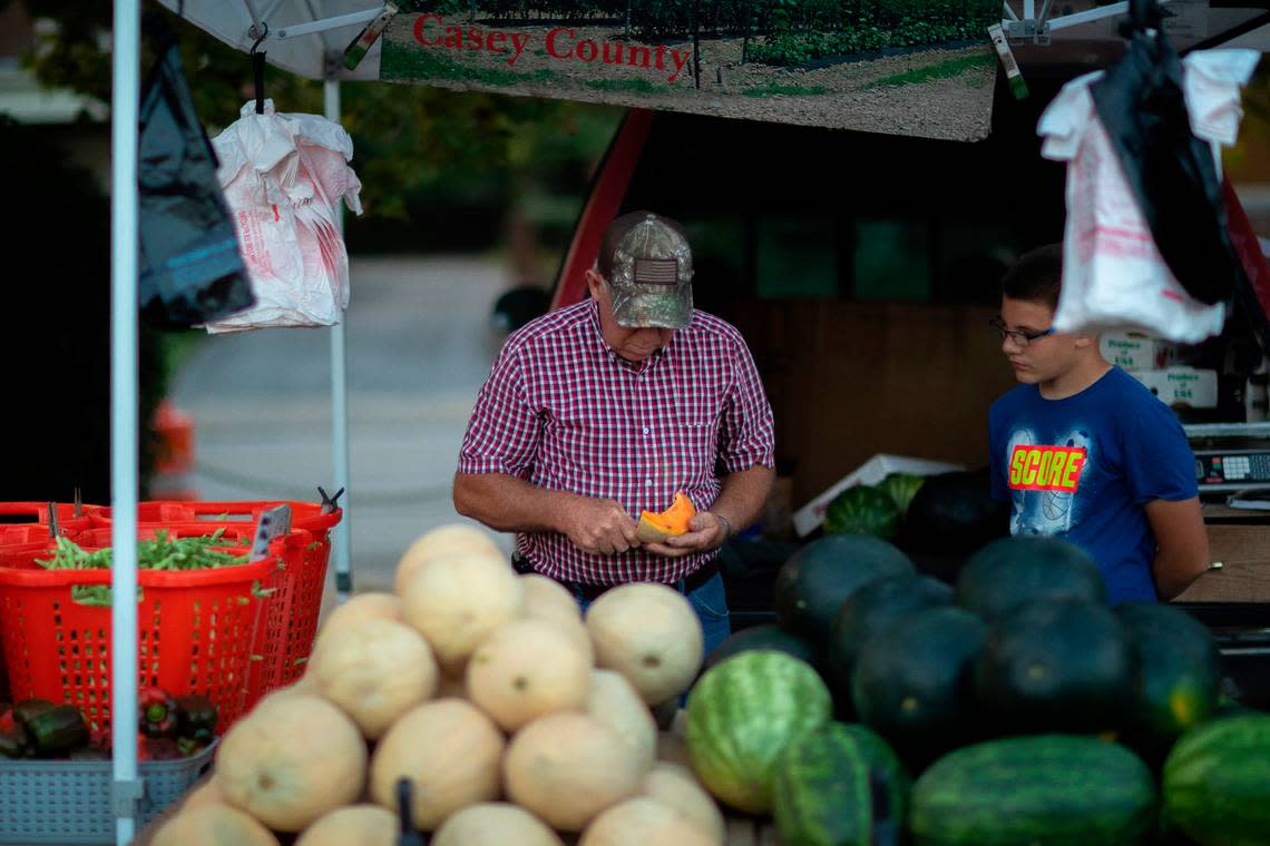 Marion Pittman, left, and Ryan Hayes, of Pittman Produce in Casey County, ready their stand at the Lexington Farmers Market at the corner of Maxwell Street and South Broadway on Thursday, Aug. 26, 2021. The Tuesday and Thursday market will be moving to National Avenue.