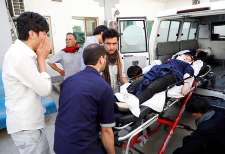 Men carry an injured at a hospital after a blast in Kabul, Afghanistan August 15, 2018. REUTERS/Mohammad Ismail