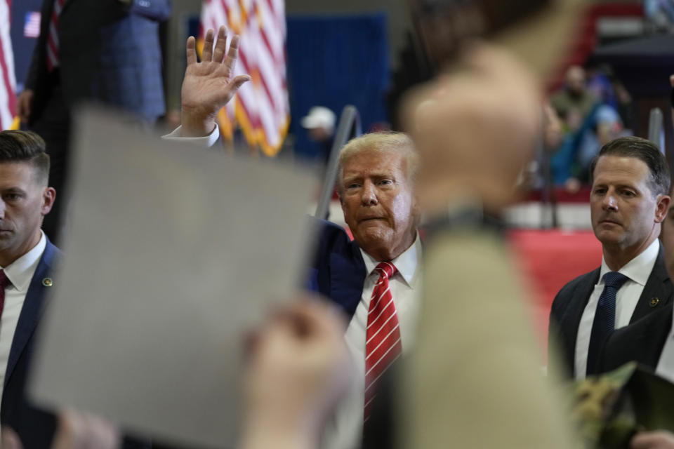 Republican presidential candidate former President Donald Trump waves after speaking during a commit to caucus rally, Saturday, Jan. 6, 2024, in Clinton, Iowa. (AP Photo/Charlie Neibergall)