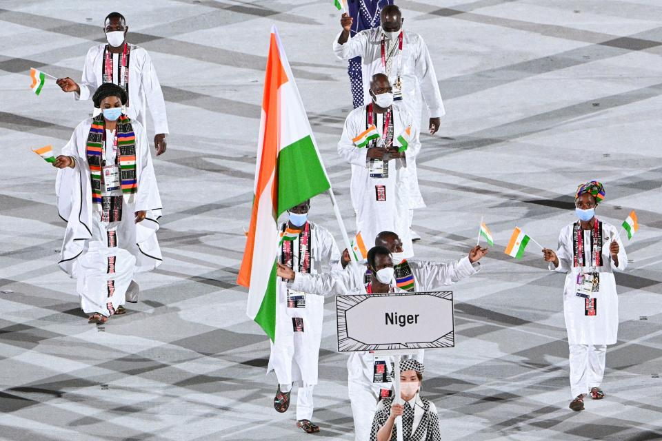 <p>Niger's delegation parade during the opening ceremony of the Tokyo 2020 Olympic Games, at the Olympic Stadium, in Tokyo, on July 23, 2021. (Photo by Martin BUREAU / AFP) (Photo by MARTIN BUREAU/AFP via Getty Images)</p> 