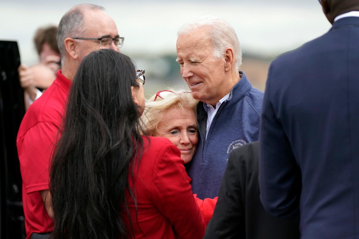 Rep. Debbie Dingell, D-Mich., hugs President Joe Biden as he arrives at Detroit Metropolitan Wayne County Airport to join striking United Auto Workers on the picket line, Tuesday, Sept. 26, 2023, in Romulus, Mich.
