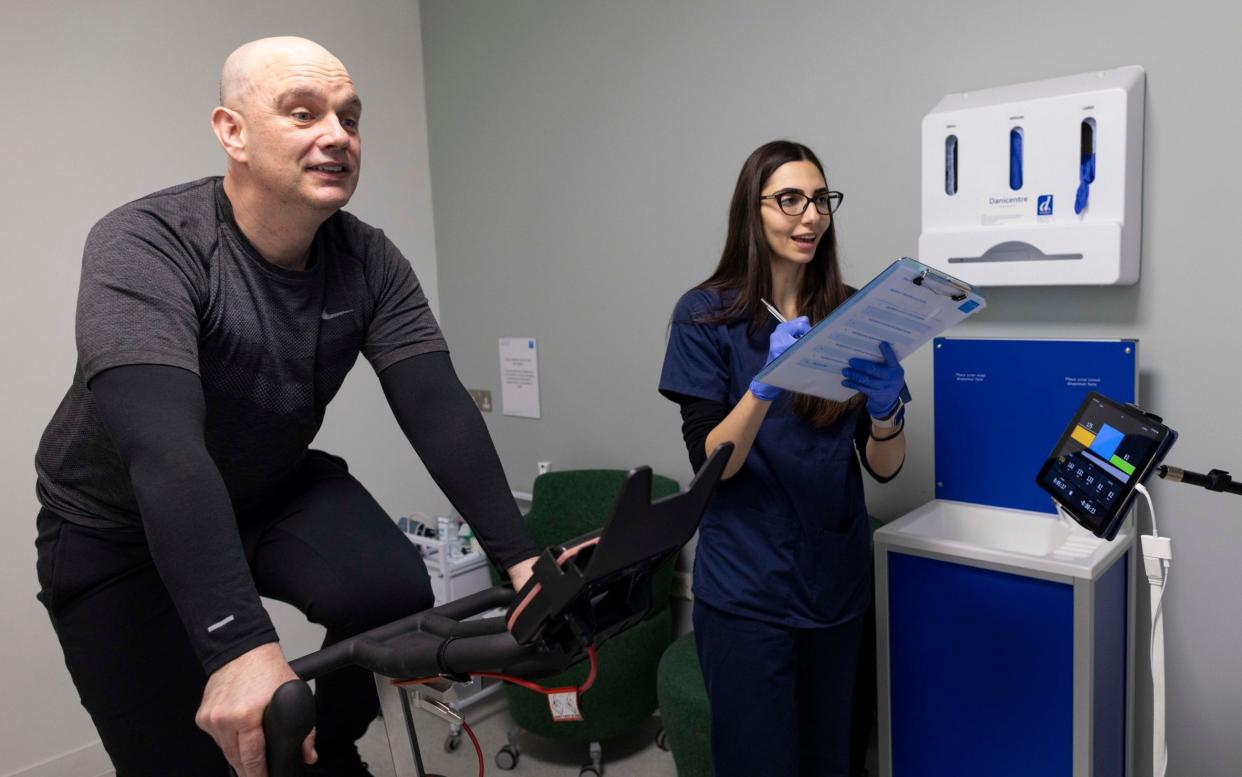 Sam Delaney has his cardiovascular details checked while exercising on a watt bike as part of Bupa's Health MOT