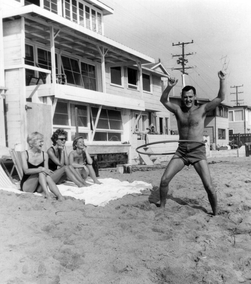 <p>Shirley MacLaine and friends watch Tony Randall hula hoop in 1958. </p>