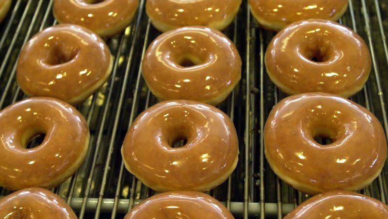 Glazed doughnuts travel along a conveyor belt to be boxed for customers at Krispy Kreme. Krispy Kreme is giving customers a free doughnut for National Doughnut Day on June 2. 