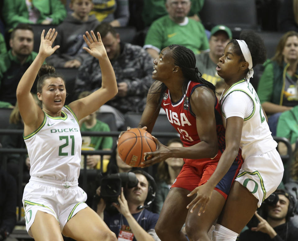 United States' Sylvia Fowles, center, looks for a shot under pressure from Oregon's Erin Boley, left, and Ruthy Hebard during the first half an exhibition basketball game in Eugene, Ore., Saturday, Nov. 9, 2019. (AP Photo/Chris Pietsch)