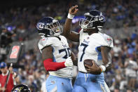 Tennessee Titans quarterback Malik Willis, right, celebrates his touchdown run with running back Julius Chestnut during the first half of a preseason NFL football game, Thursday, Aug. 11, 2022, in Baltimore. (AP Photo/Gail Burton)