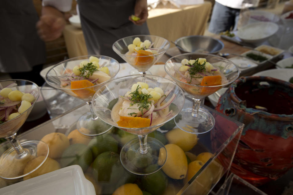 Patrons at the launch of Miami's newest Peruvian cafe, LeMar, were served "Ceviche Mixto", Wednesday, Dec. 18 213. The cafe will be operated by Chef Gaston Acurio, who owns 40 cafes around the world. The dish consists of fish and shrimp along with rocotto leche served with sweet potato and Peruvian corn. (AP Photo/J Pat Carter)