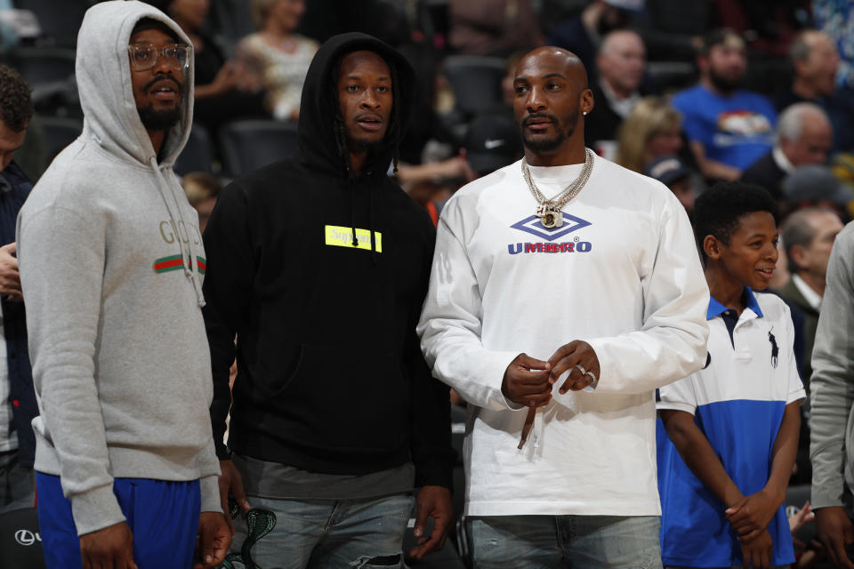 From left, Denver Broncos linebacker Von Miller and Los Angeles Rams running back Todd Gurley and cornerback Aqib Talib hang out in Denver at an NBA game this week. (AP)