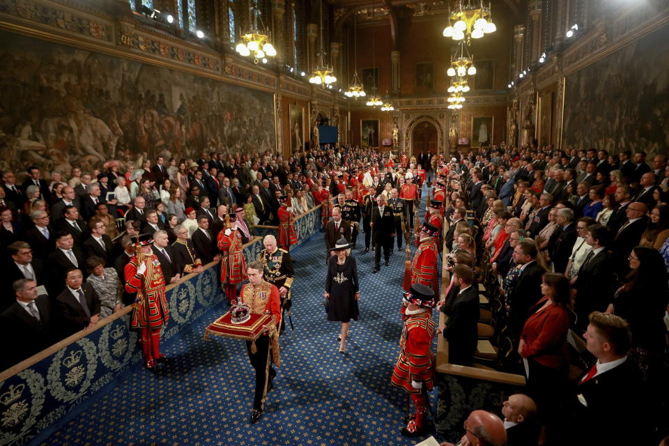 Britain's Prince Charles, Camilla, Duchess of Cornwall and Britain's Prince William proceed behind the Imperial State Crown through the Royal Gallery for the State Opening of Parliament at the Palace of Westminster in London, Tuesday, May 10, 2022. Britain’s Parliament opens a new year-long session on Tuesday with a mix of royal pomp and raw politics, as Prime Minister Boris Johnson tries to re-energize his scandal-tarnished administration and revive the economy amid a worsening cost-of-living crisis. (Hannah McKay/Pool via AP)