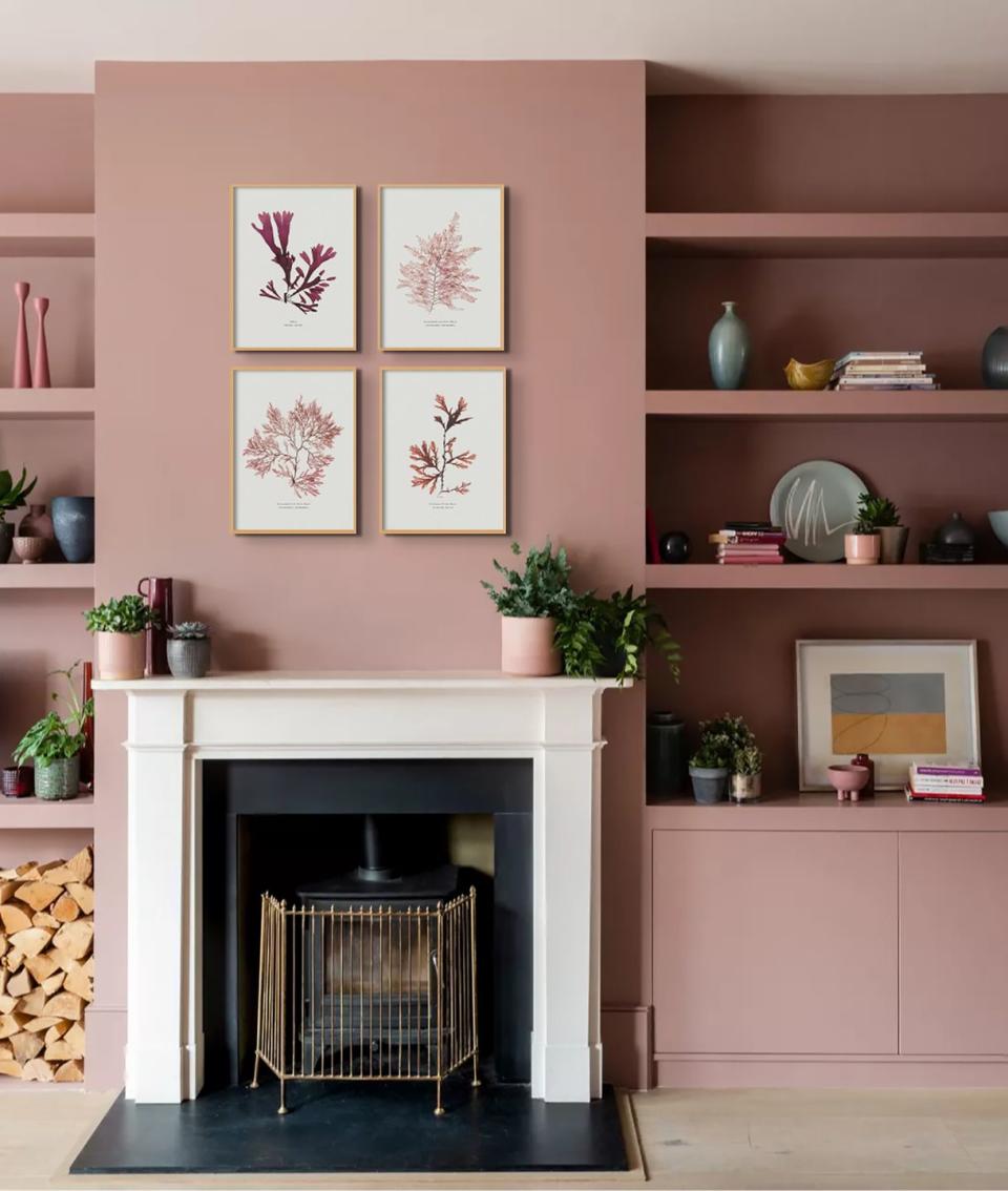 pink living room with wall art above fireplace