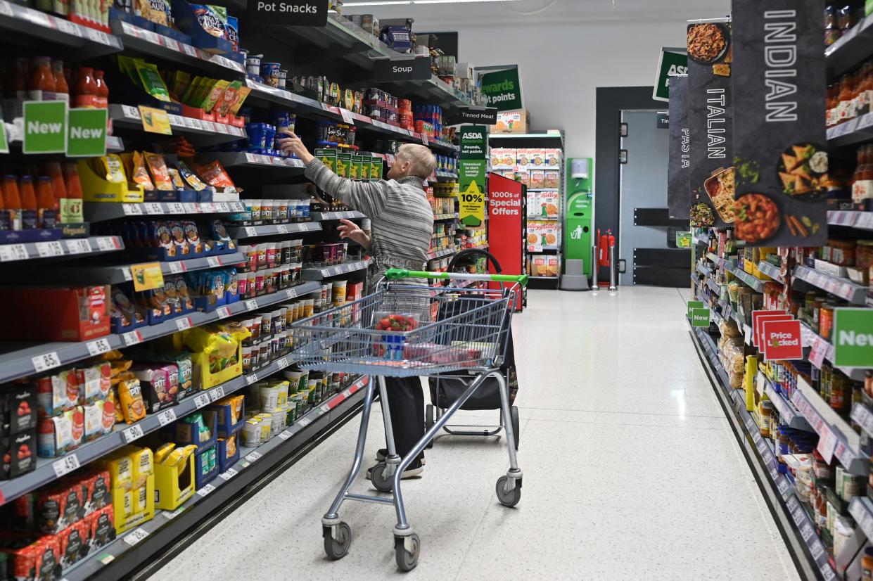 A customer looks at some goods at the Asda supermarket, in Aylesbury, England, on August 15, 2023. UK annual inflation stands at 7.9 percent, the highest among G7 nations, while the Bank of England is tasked by the UK government with keeping annual inflation at around two percent. (Photo by JUSTIN TALLIS / AFP) (Photo by JUSTIN TALLIS/AFP via Getty Images)