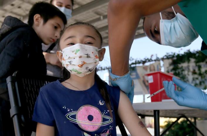 LYNWOOD, CALIF. - MAR. 16, 2022. Amaya Palestino, 6, gets immunized with the Pfizer vaccine at Hellen Keller Elementary School in Lynwood on Wednesday, Mar. 16, 2022. (Luis Sinco / Los Angeles Times)