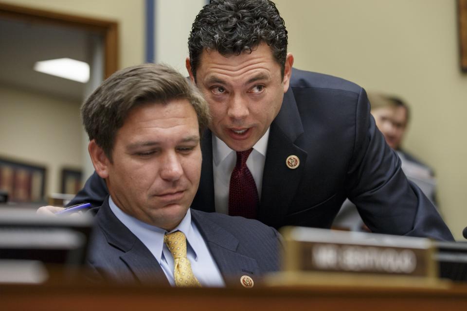 Former Reps. Jason Chaffetz, R-Utah, right, and Ron DeSantis, R-Fla., confer on Capitol Hill in Washington, on Tuesday, Sept. 30, 2014, during a congressional hearing. | J. Scott Applewhite, Associated Press