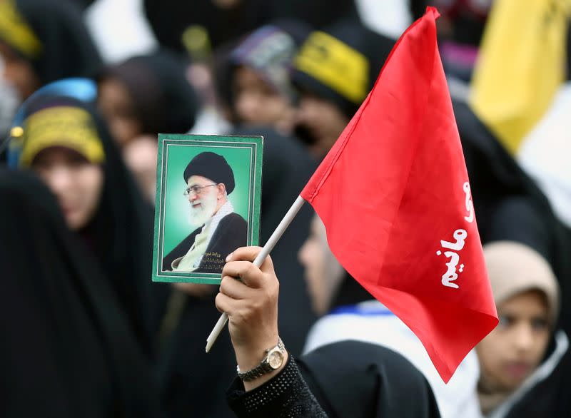 FILE PHOTO: An Iranian protester holds the picture of Iranian Supreme Leader Ayatollah Ali Khamenei as she attends an anti U.S. demonstration, marking the 40th anniversary of the U.S. embassy takeover, near the old U.S. embassy in Tehran