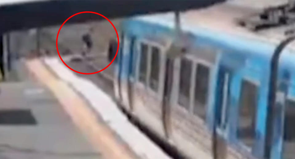 Schoolchildren are seen dodging a train just to save a few minutes. Source: 7 News