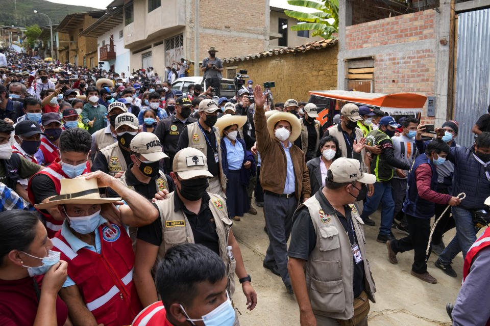 Presidential candidate Pedro Castillo waves to supporters after voting in Tacabamba, Peru, Sunday, June 6, 2021. Peruvians voted Sunday in a presidential run-off election to choose between Castillo, a political novice who until recently was a rural schoolteacher, and Keiko Fujimori, the daughter of jailed ex-President Alberto Fujimori. (AP Photo/Martin Mejia)