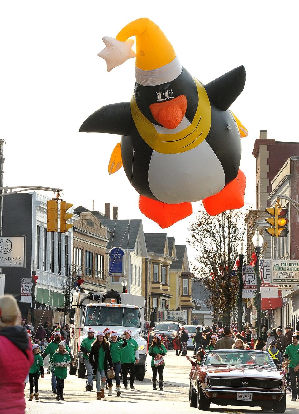 "Peter Penguin" flies up South Main Street, piloted by a group from Liberty Utilities,during the Fall River Children's Holiday Parade, Saturday, December 1, 2018, in Fall River, Massachusetts.
