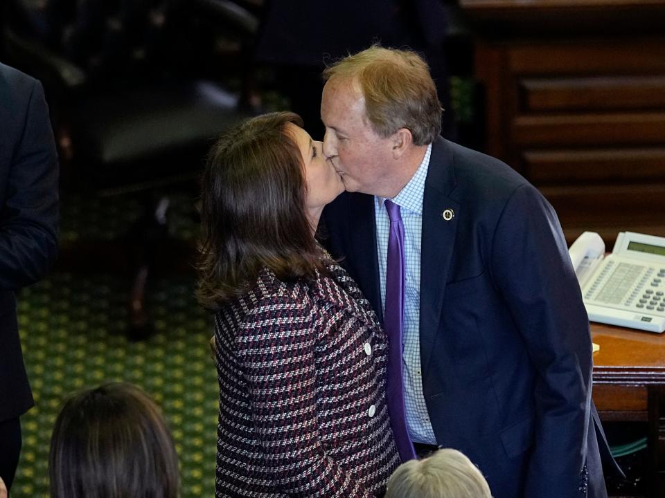 Texas Attorney General Ken Paxton kisses his wife Sen. Angela Paxton after he was sworn in for a third term on January 10, 2023.