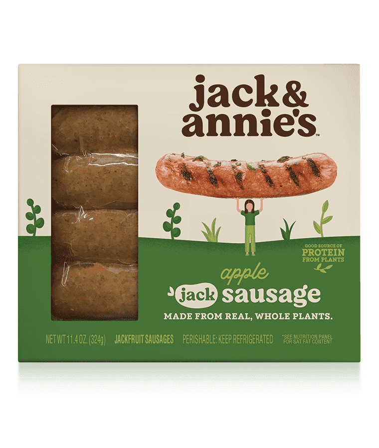 Packaging of jack & annie's apple sausage, made from real, whole plants. The package shows sausages through a transparent section and a character holding a large sausage