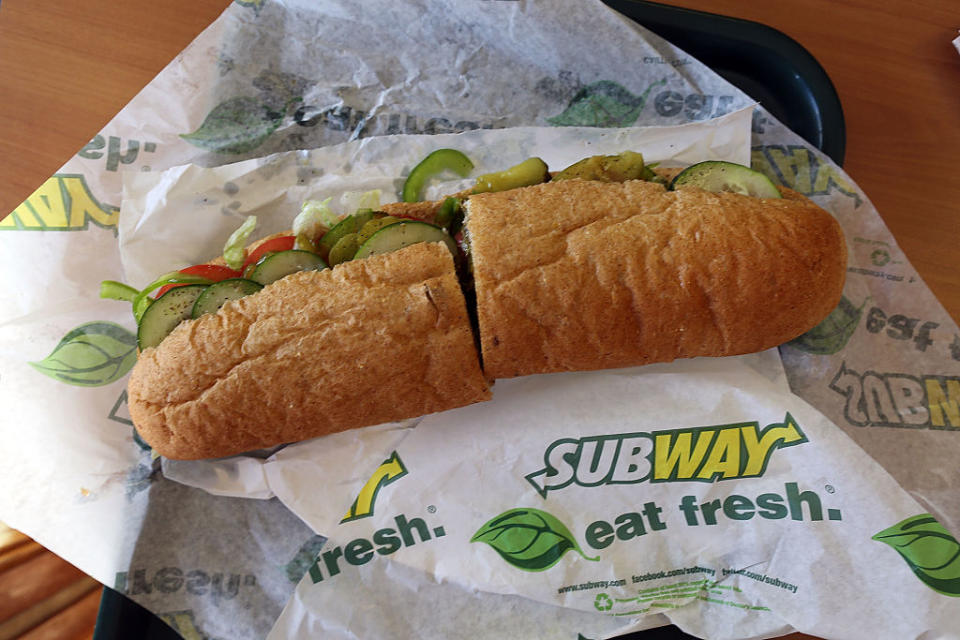 Subway sandwich with vegetables on branded paper