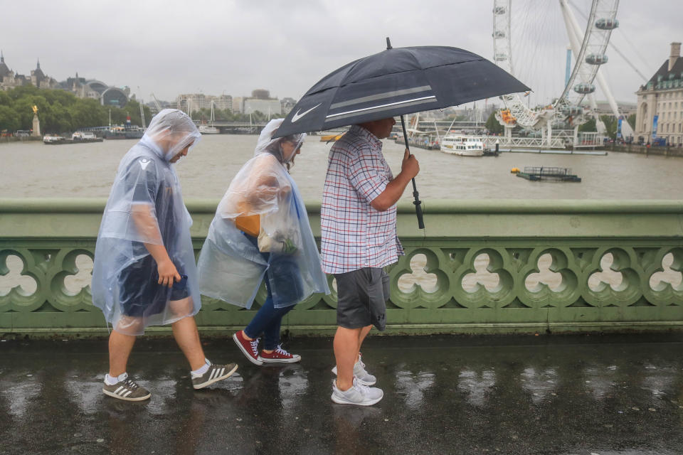 Pedestrians on Westminster Bridge with rain ponchos and an umbrella during rain showers as a month's rainfall was expected in three hours with the risk of flooding in some areas of the United Kingdom. (Photo by Amer Ghazzal / SOPA Images/Sipa USA)