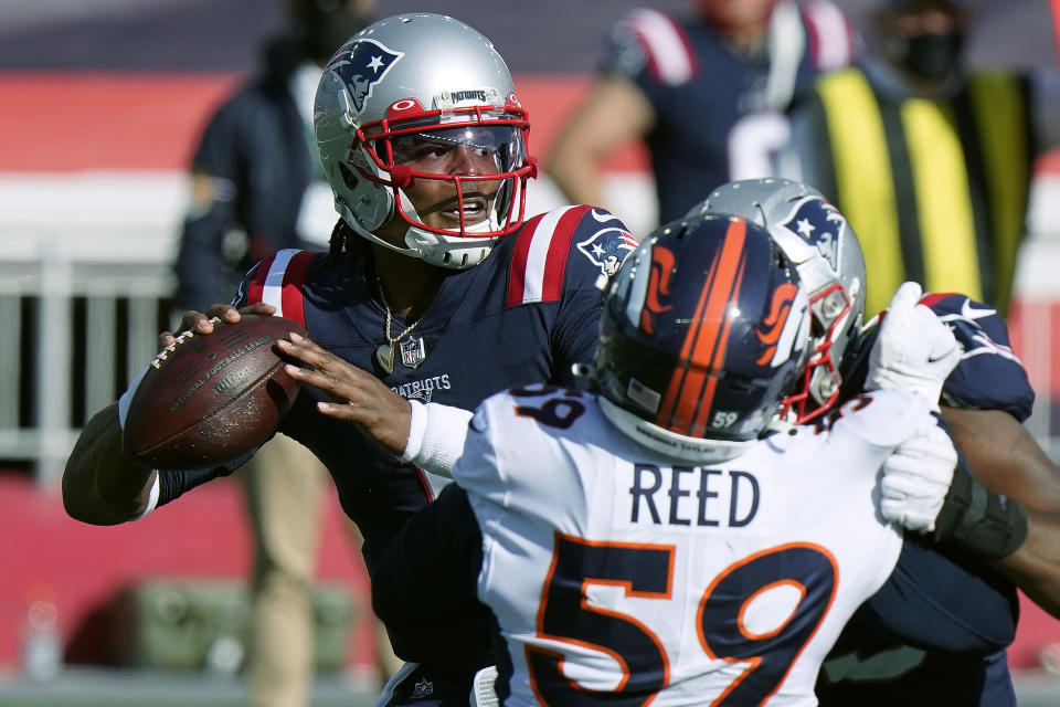 New England Patriots quarterback Cam Newton, right, passes under pressure from Denver Broncos linebacker Malik Reed (59) in the second half of an NFL football game, Sunday, Oct. 18, 2020, in Foxborough, Mass. (AP Photo/Steven Senne)