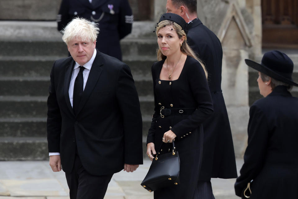 LONDON, ENGLAND - SEPTEMBER 19: Former Prime Minister of the United Kingdom Boris Johnson and Carrie Johnson arrive at Westminster Abbey ahead of The State Funeral of Queen Elizabeth II at Westminster Abbey on September 19, 2022 in London, England. Elizabeth Alexandra Mary Windsor was born in Bruton Street, Mayfair, London on 21 April 1926. She married Prince Philip in 1947 and ascended the throne of the United Kingdom and Commonwealth on 6 February 1952 after the death of her Father, King George VI. Queen Elizabeth II died at Balmoral Castle in Scotland on September 8, 2022, and is succeeded by her eldest son, King Charles III.  (Photo by Chris Jackson/Getty Images)