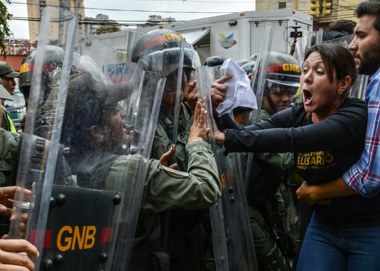 Venezuelan opposition deputy Amelia Belisario (2nd-R) scuffles with National Guard during a protest in front of the Supreme Court in Caracas